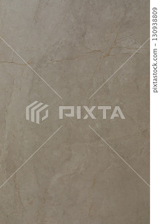 Smooth beige stone surface with subtle variations in color and texture showing natural beauty and 130938809