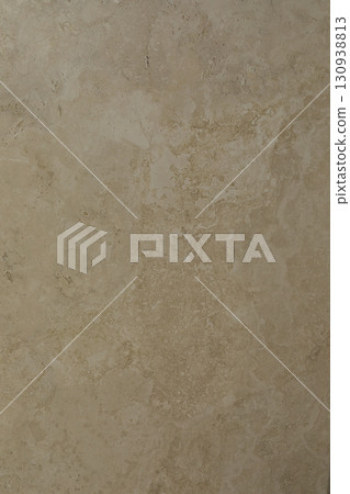 Texture of a natural stone wall showcasing earthy tones and patterns in a cozy indoor space 130938813