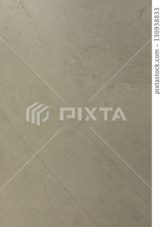 Smooth beige marble surface with fine veins in natural light creating a subtle textured look Smooth beige marble surface with fine veins in natural light creating a subtle textured look 130938833