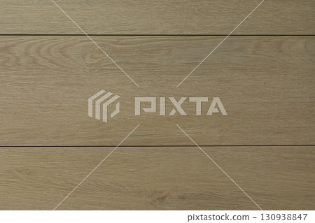 Natural light wood flooring with a smooth texture and warm tones in a cozy interior space 130938847