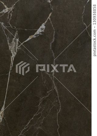 Dark marble surface with white veining showcasing a unique natural pattern and texture ideal for Dark marble surface with white veining showcasing a unique natural pattern and texture ideal for 130938858