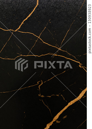 Black marble surface with golden veins showcasing natural elegance and textural beauty 130938923