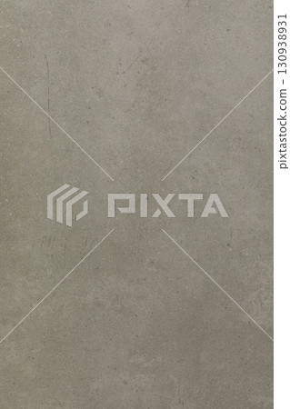 Textured grey wall with subtle variations and light shadows in a minimalist setting 130938931