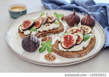 Sandwiches with figs, cream cheese, basil and honey on plate Sandwiches with figs, cream cheese, basil and honey on plate 130939831