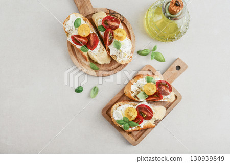 Bruschetta sandwiches with tomatoes, cream cheese, olive oil and basil Bruschetta sandwiches with tomatoes, cream cheese, olive oil and basil 130939849