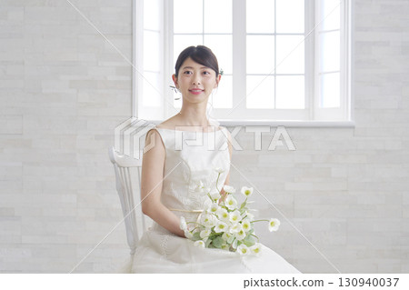 Portrait of a woman in her 20s wearing a wedding dress Portrait of a woman in her 20s wearing a wedding dress 130940037