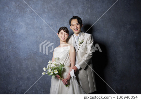 Bride and groom portrait black background looking at camera Bride and groom portrait black background looking at camera 130940054