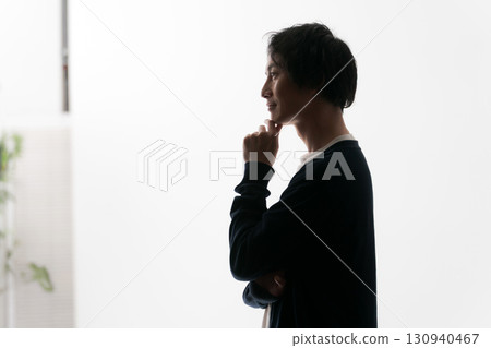 Silhouette of a worried man Silhouette of a worried man 130940467
