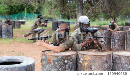 Portrait of two confident male paintball players in masks Portrait of two confident male paintball players in masks 130940686