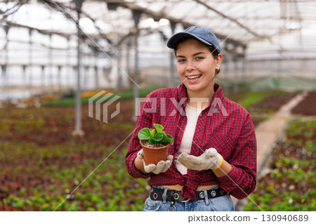 Young woman posing with pot of peppermint Young woman posing with pot of peppermint 130940689