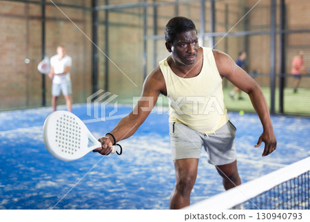 African american man playing paddle tennis 130940793