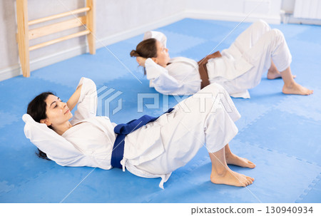 Two women training their abs in studio 130940934