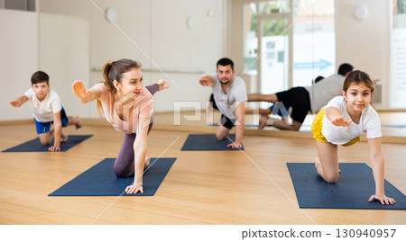 Kids and parents doing bird dog exercise in gym Kids and parents doing bird dog exercise in gym 130940957