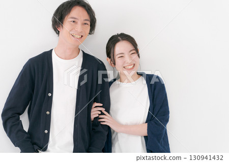 Male and female couple standing side by side 130941432