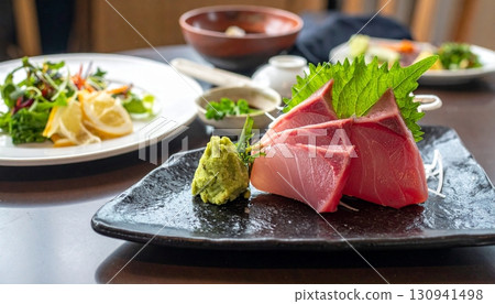 Raw fish slice and oyster serve with wasabi on the table 130941498