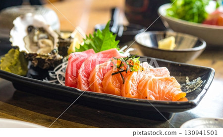 Raw fish slice and oyster serve with wasabi on the table Raw fish slice and oyster serve with wasabi on the table 130941501