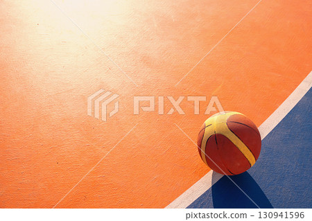 Basketball on the orange court for sport advertisement. 130941596