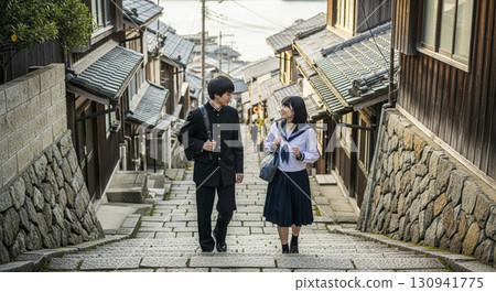 High school students walking and chatting on the stone steps of an old Japanese town 130941775