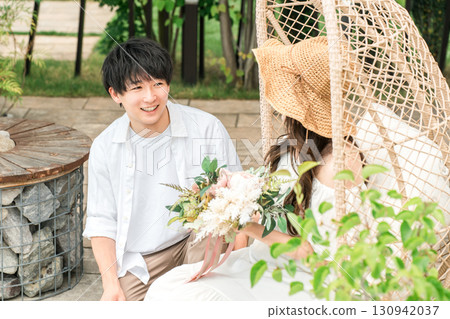 Couple proposing by the pool at a resort hotel on a trip 130942037
