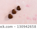 Miniature cookies made from bread clay, heart chocolate, pink background 130942658