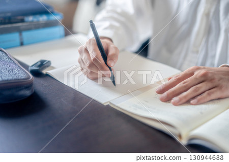 Hand holding a pen Hand holding a pen 130944688