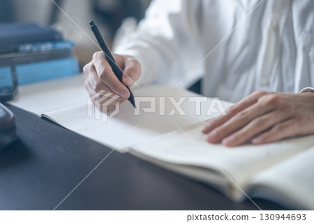 Hand holding a pen 130944693