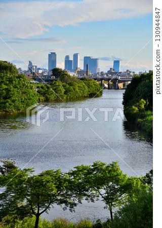 Kasugai City, Aichi Prefecture: Nagoya Station skyscrapers seen from the confluence of the Hatta River and Shonai River 130944847