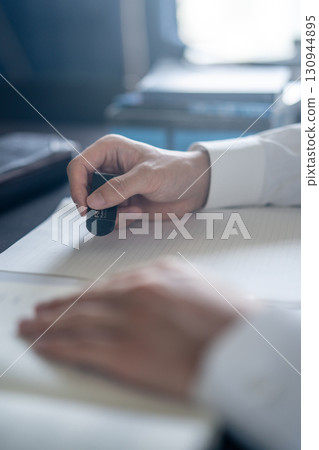 Hand holding an eraser 130944895