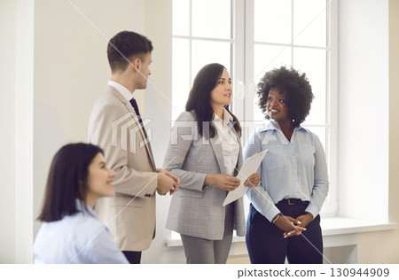 Businesswoman Leading Presentation For Team In Office 130944909