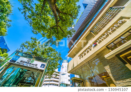 Tokyo cityscape in Japan: Omotesando, Tokyo. Green trees, Meiji-Jingumae (Harajuku) Station, Tokyu Plaza, Tommy Hilfiger 130945107