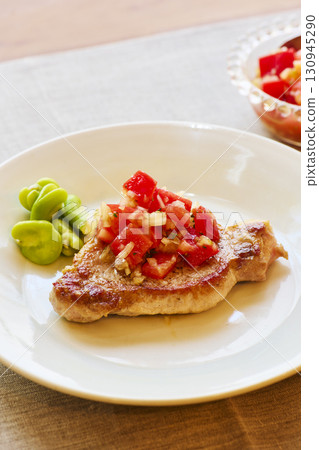 Sautéed pork with tomato salsa and broad beans Sautéed pork with tomato salsa and broad beans 130945290