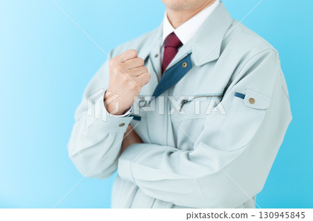 A middle-aged male businessman in work clothes making a fist pump A middle-aged male businessman in work clothes making a fist pump 130945845
