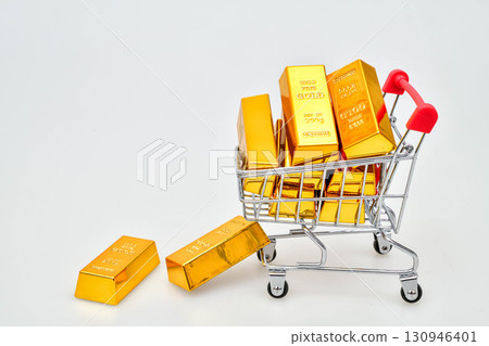 Gold bars in shopping cart isolated on white background Gold price rising all time high, high demand purchasing Gold bars in shopping cart isolated on white background Gold price rising all time high, high demand purchasing 130946401
