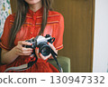 A woman taking a picture 130947332