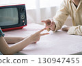 Male and female playing a scissors game 130947455