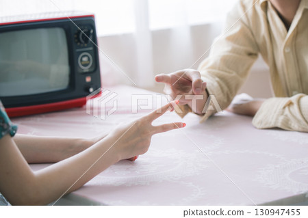 Male and female playing a scissors game 130947455