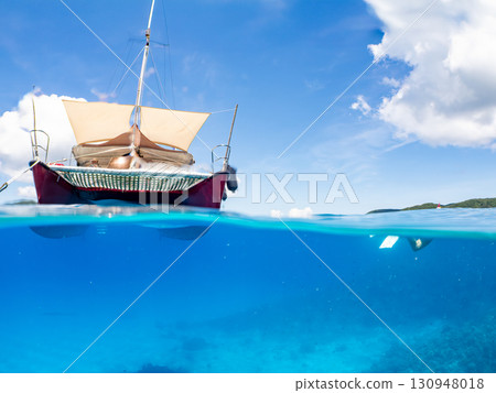 Partially submerged shot of a catamaran yacht diving cruise ship. Beautiful coral reefs and schools of tropical fish. Kera, Shimajiri District, Okinawa Prefecture Partially submerged shot of a catamaran yacht diving cruise ship. Beautiful coral reefs and schools of tropical fish. Kera, Shimajiri District, Okinawa Prefecture 130948018