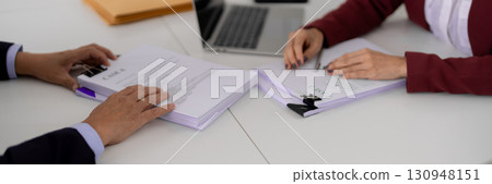 Legal professionals review case documents business agreements client consultations office meeting discussing law regulations paperwork analysis 130948151