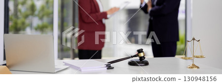Legal Professionals Discuss Law Documents Modern Office Setting Consultation Meeting Justice System Work 130948156