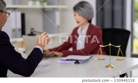 Asian adult lawyers discuss legal strategy client consultation office justice advice professional meeting law firm business document 130948158