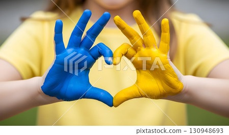 Hands forming a heart with Ukraine's colors 130948693