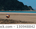 Volleyball rolling on the beach 130948842