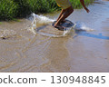 Skimboarding on the river 130948845