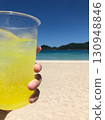 Drinking juice on a beautiful tropical beach 130948846