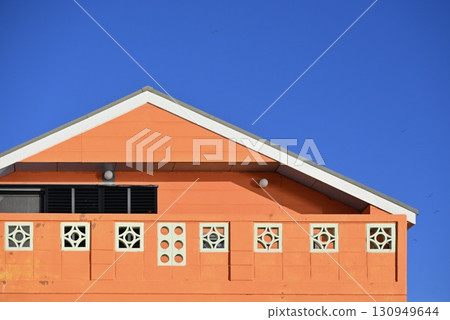 Orange house against the blue sky 130949644