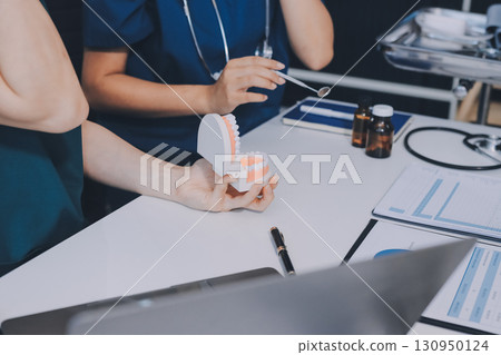 dentist consultation - patient visit at dental clinics office 130950124