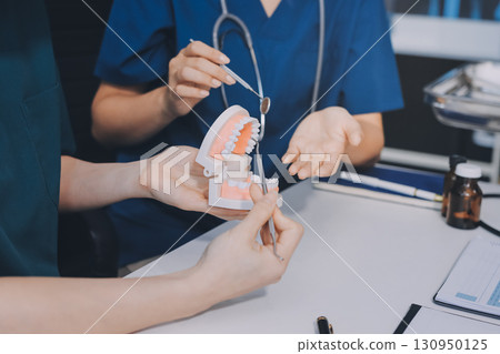 dentist consultation - patient visit at dental clinics office 130950125