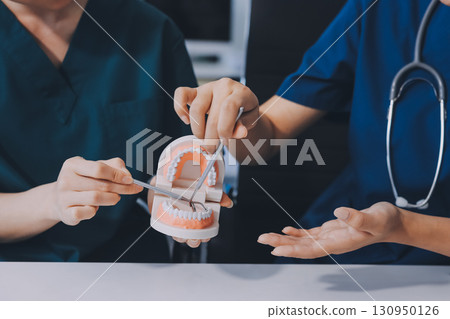 dentist consultation - patient visit at dental clinics office 130950126