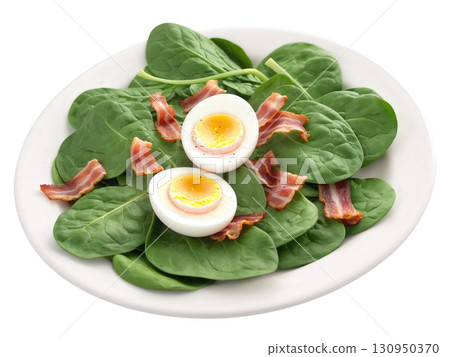 Spinach Salad Fresh spinach leaves topped with red onions, hard-boiled eggs, crumbled bacon, and a warm bacon dressing. The spinach 130950370