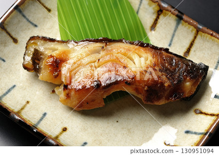 Grilled silver cod in Kyoto style on a black background Grilled silver cod in Kyoto style on a black background 130951094
